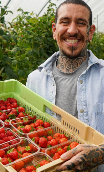 Alessandro Vitale aka Spicy Moustache holding a bunch of organic berries