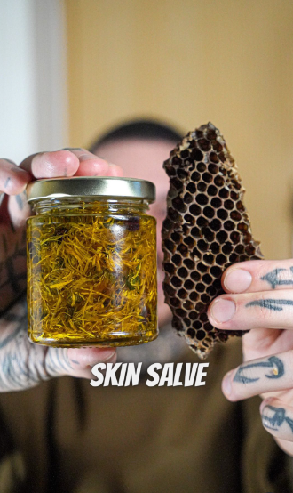 Alessandro Vitale aka Spicy Moustache holding beeswax and calendula flower