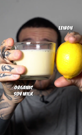 Alessandro Vitale aka Spicy Moustache holding a lemon and organic soy milk