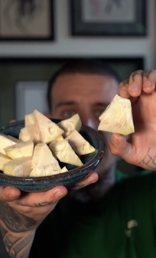 Alessandro Vitale aka Spicy Moustache holding jackfruit in a plate